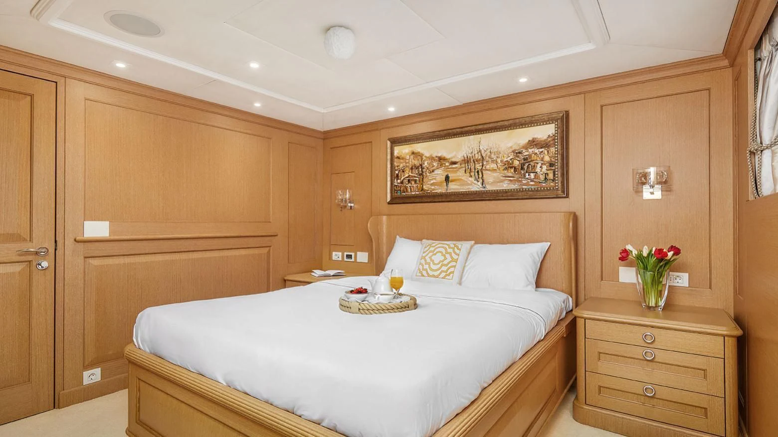 a bed with a white bed spread aboard VERA Yacht for Sale