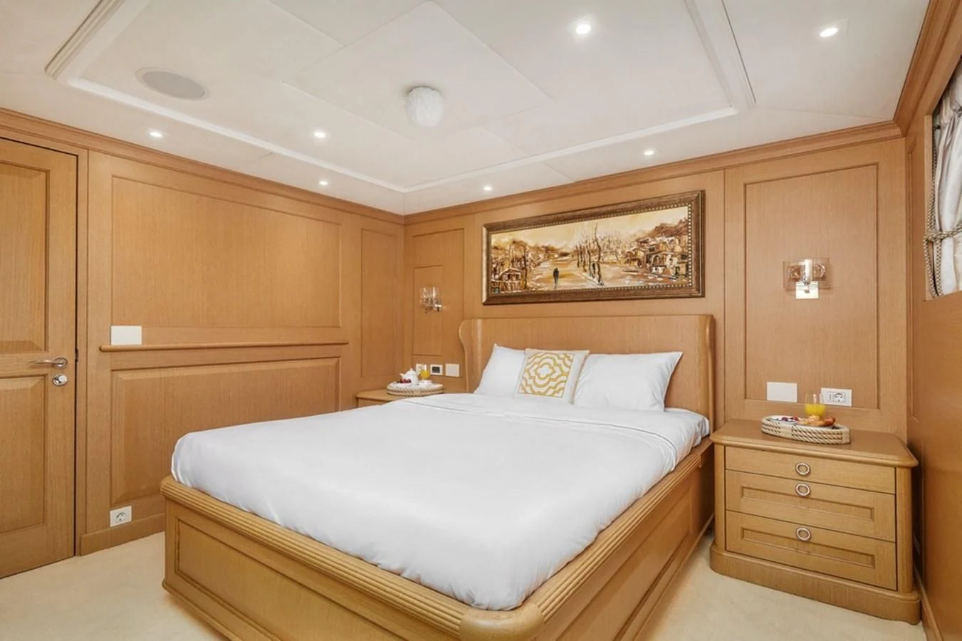 a bedroom with a bed and cabinets aboard VERA Yacht for Sale