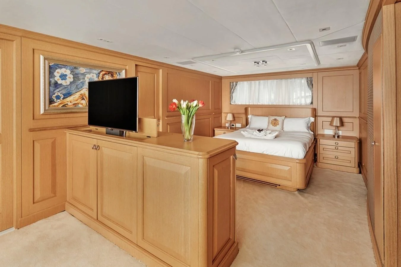 a bedroom with a bed and a tv aboard VERA Yacht for Sale
