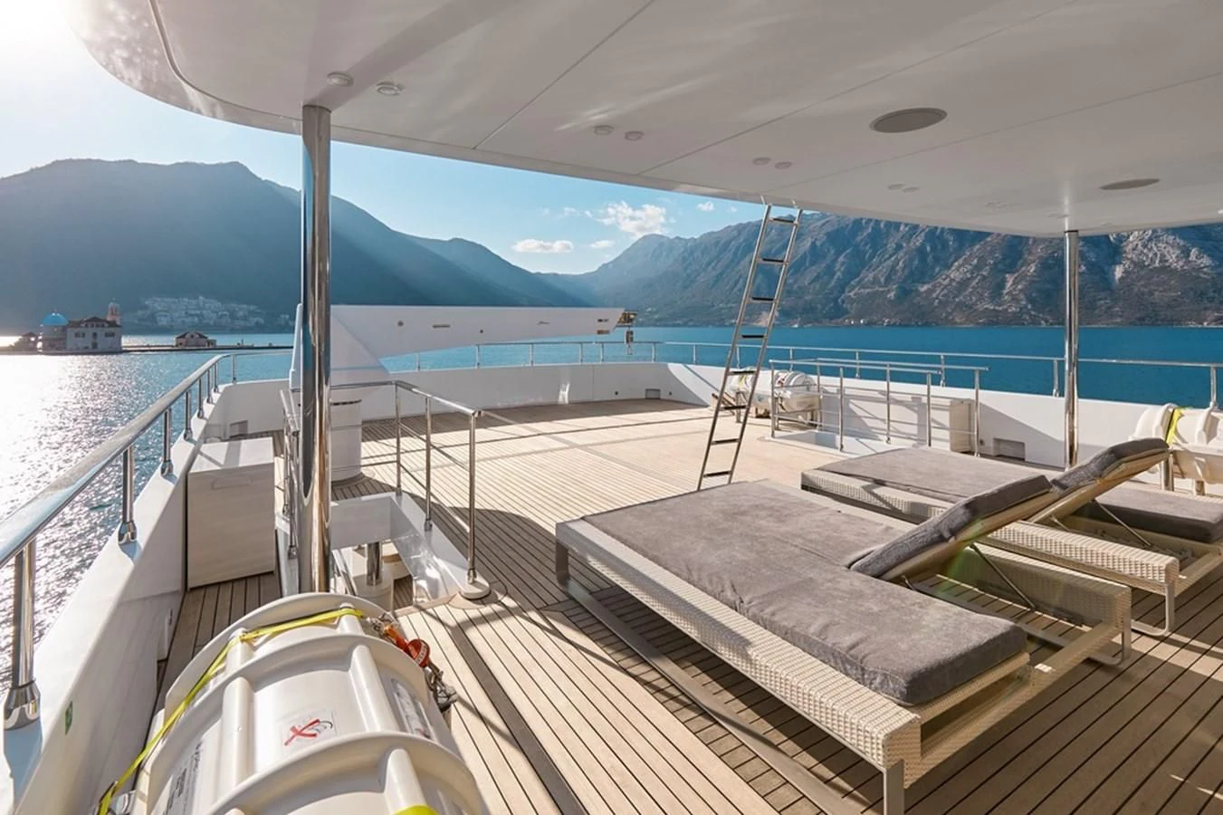 a deck with a deck and a view of the water aboard VERA Yacht for Sale
