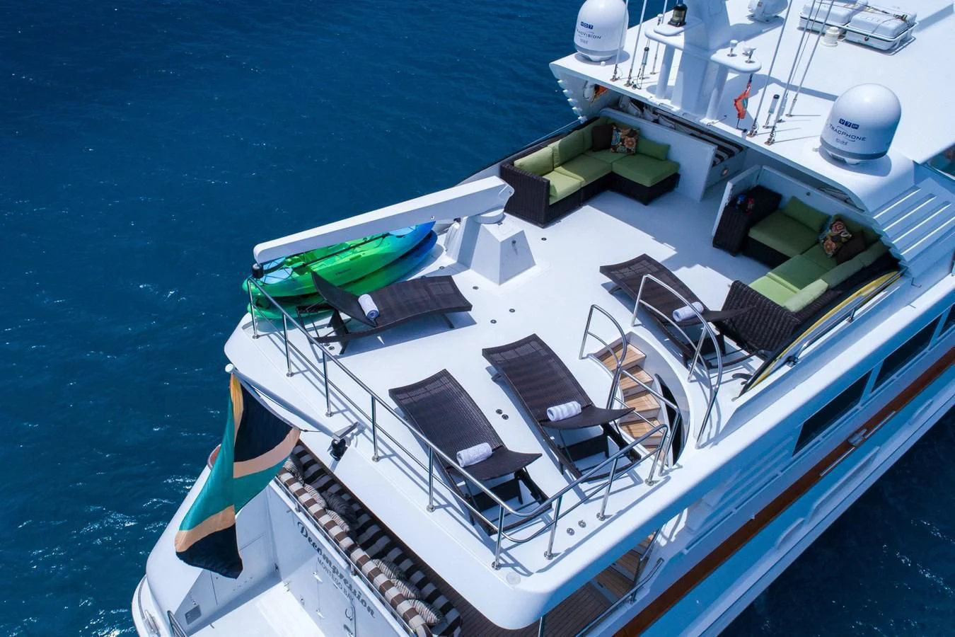 a large white boat with a green and white boat on it aboard THREE KINGS Yacht for Sale
