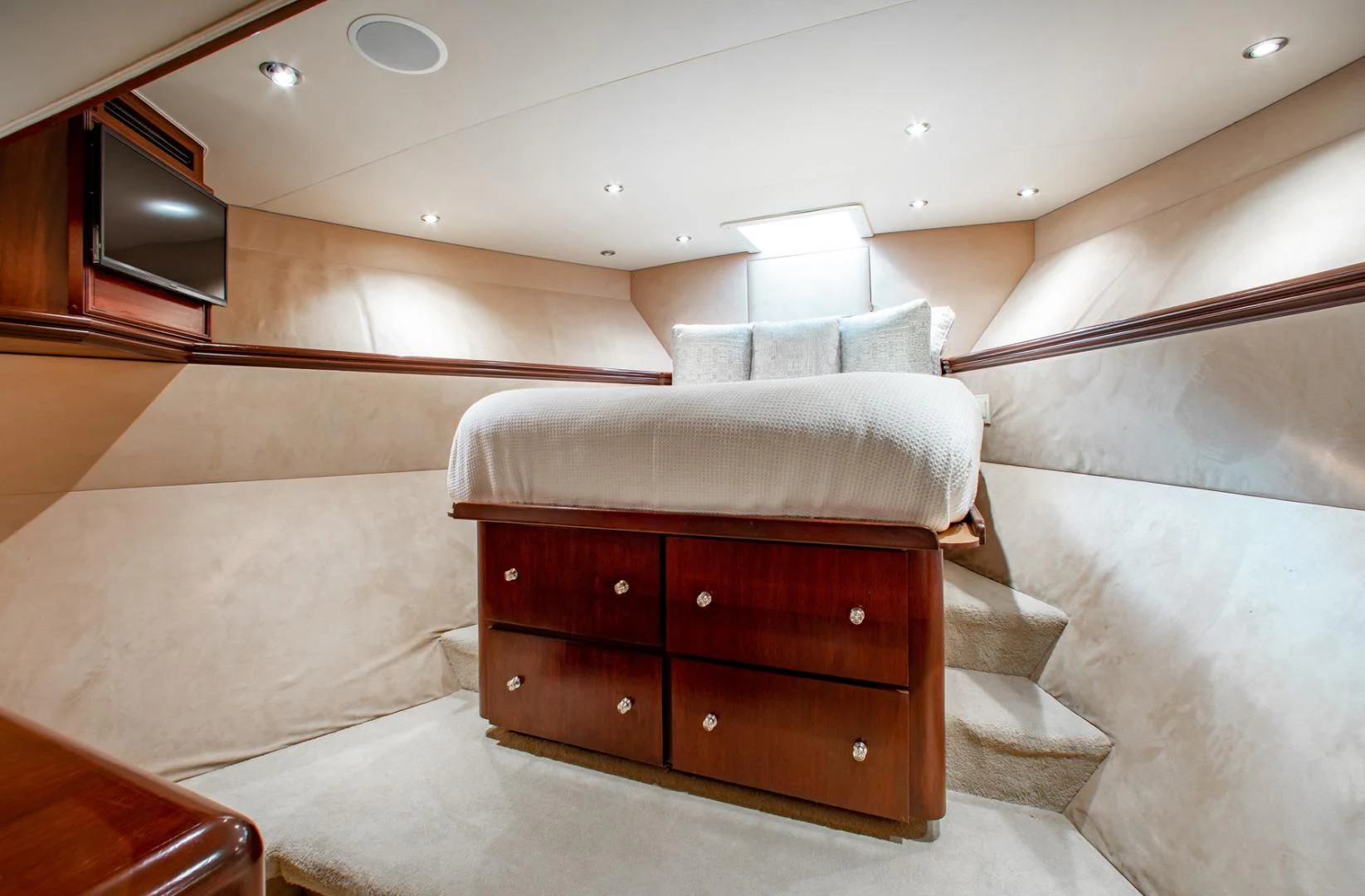 a room with a bed and a dresser aboard THREE KINGS Yacht for Sale