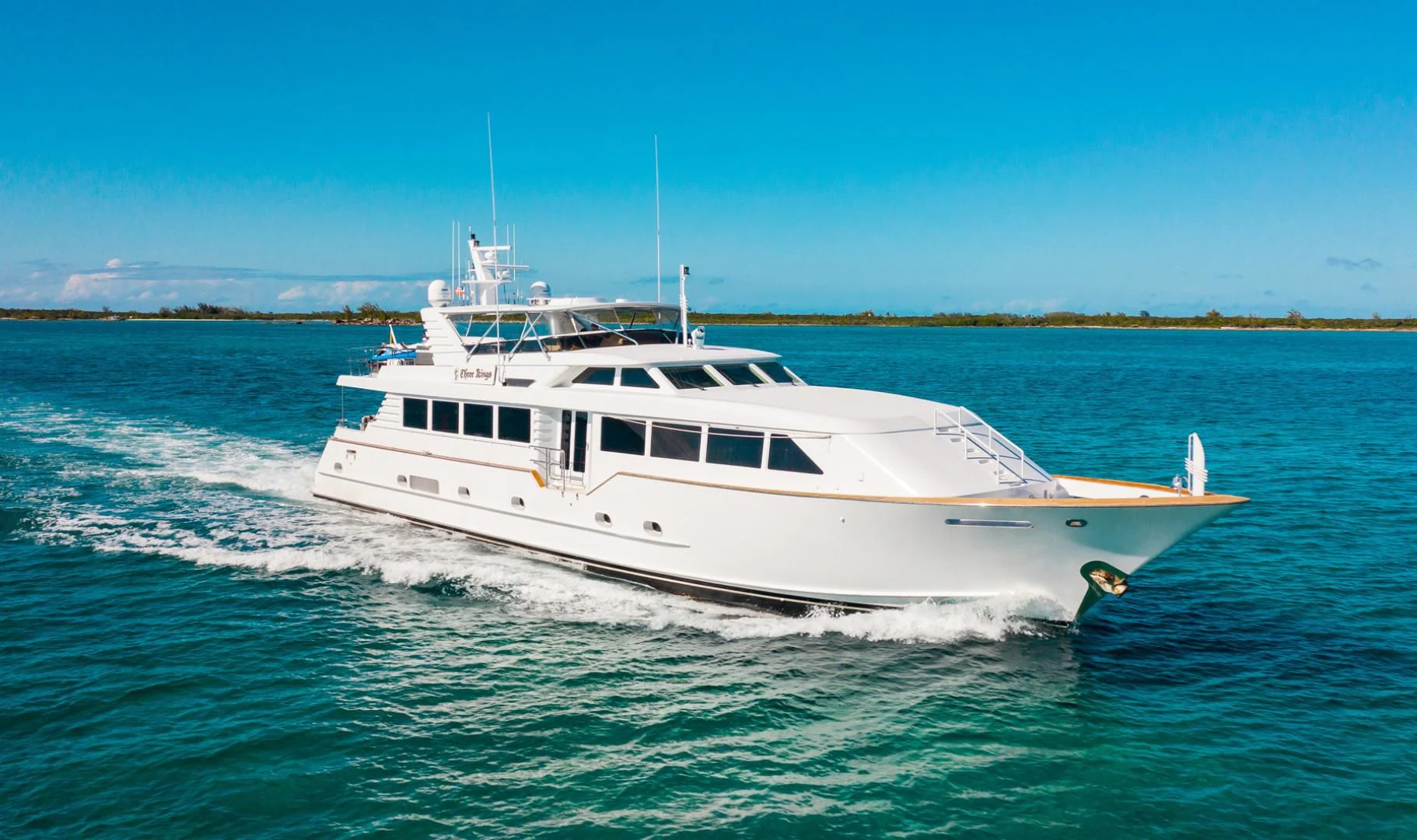 a white yacht on the water aboard THREE KINGS Yacht for Sale