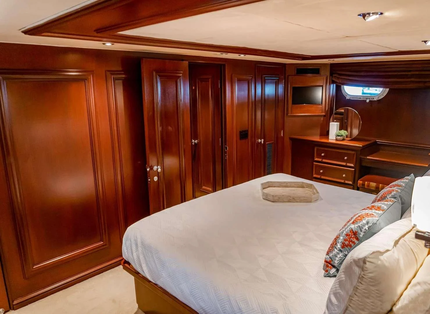 a bedroom with a bed and cabinets aboard THREE KINGS Yacht for Sale