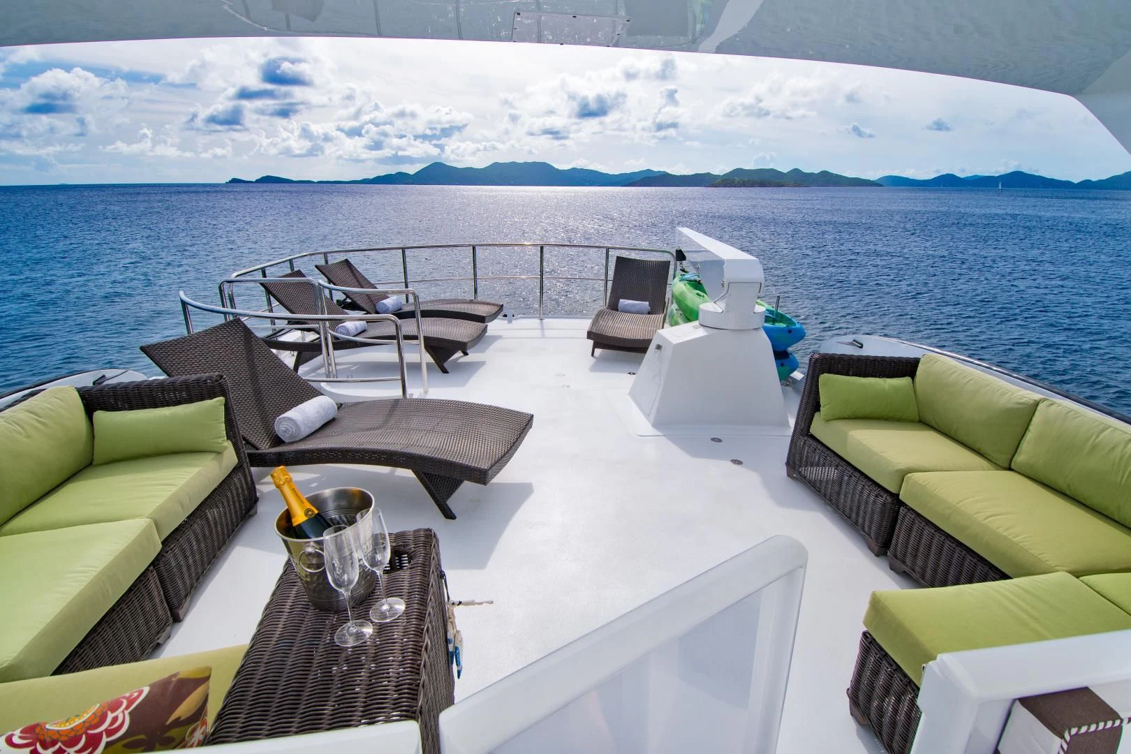 a deck with chairs and a table on it aboard THREE KINGS Yacht for Sale