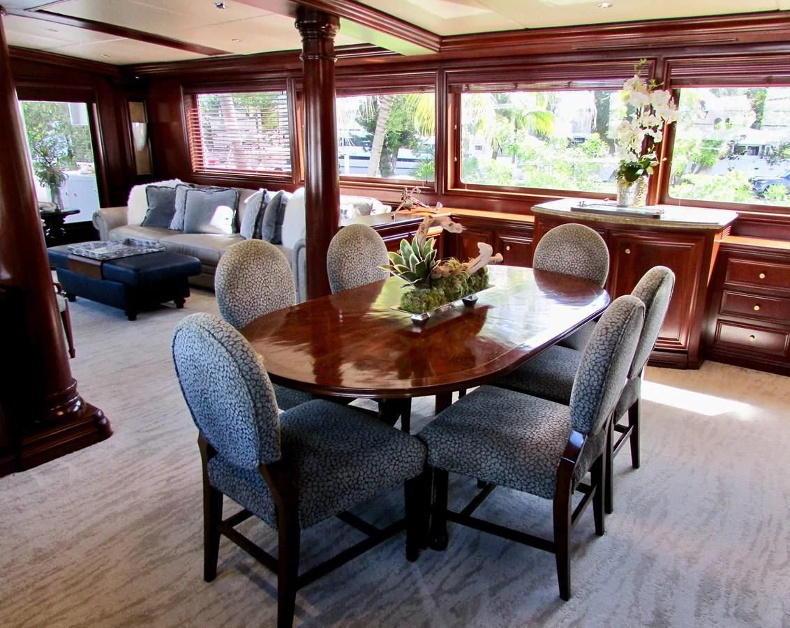 a dining table in a living room aboard THREE KINGS Yacht for Sale