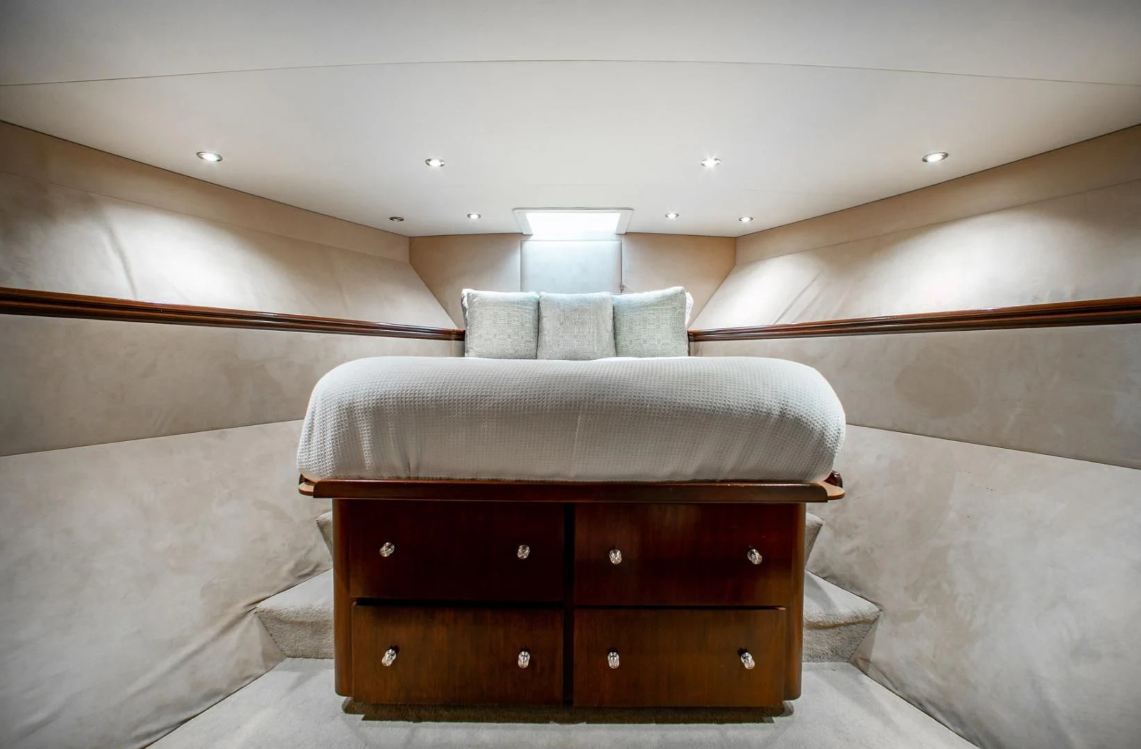 a bed with a wooden headboard aboard THREE KINGS Yacht for Sale