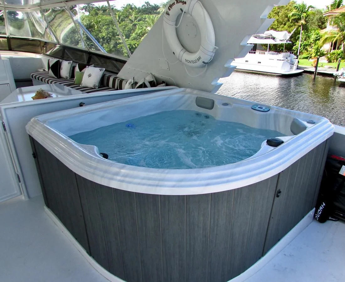 a large blue tub with a white lid and a white boat in the background aboard THREE KINGS Yacht for Sale