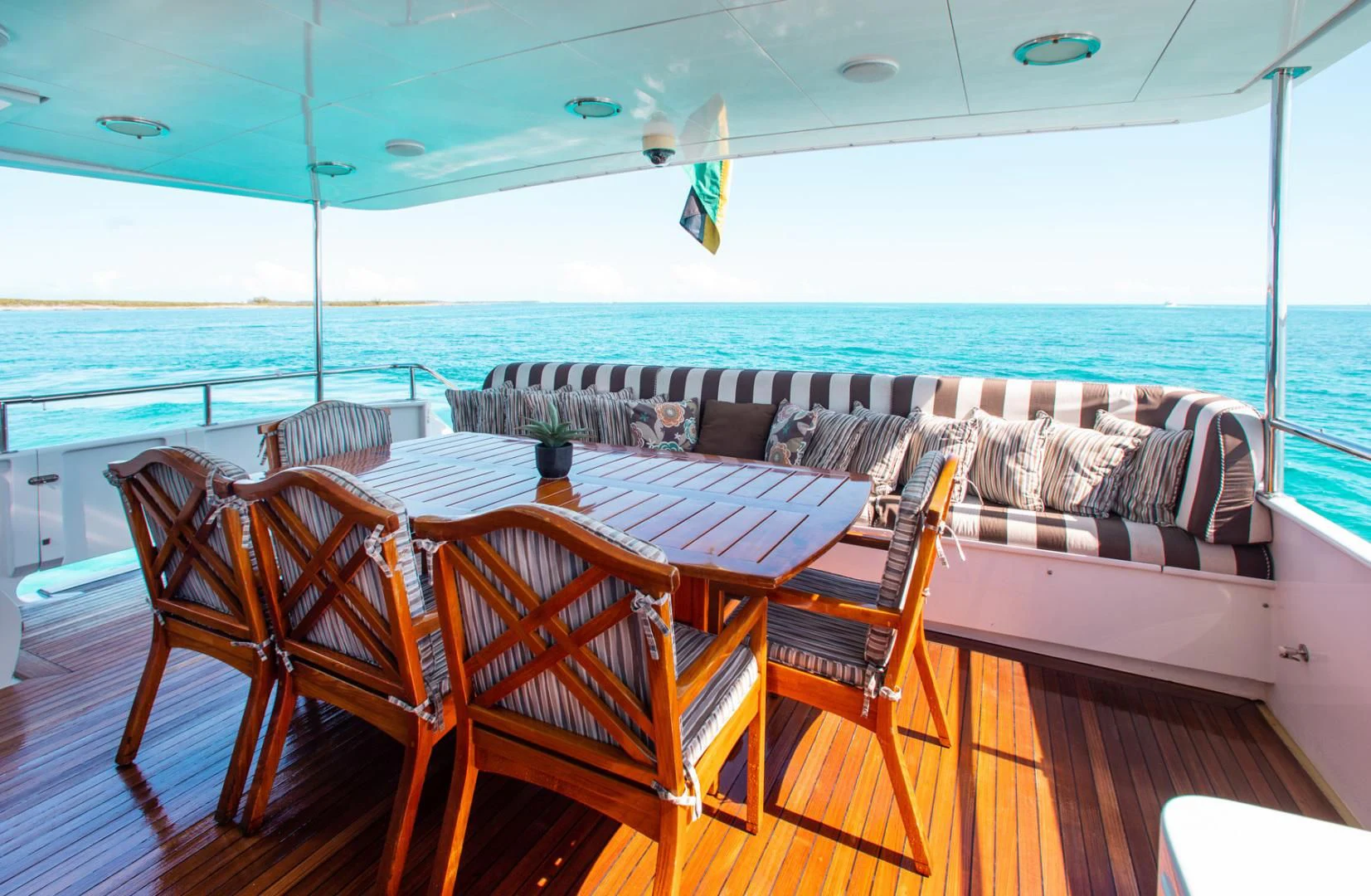 a table and chairs on a balcony aboard THREE KINGS Yacht for Sale
