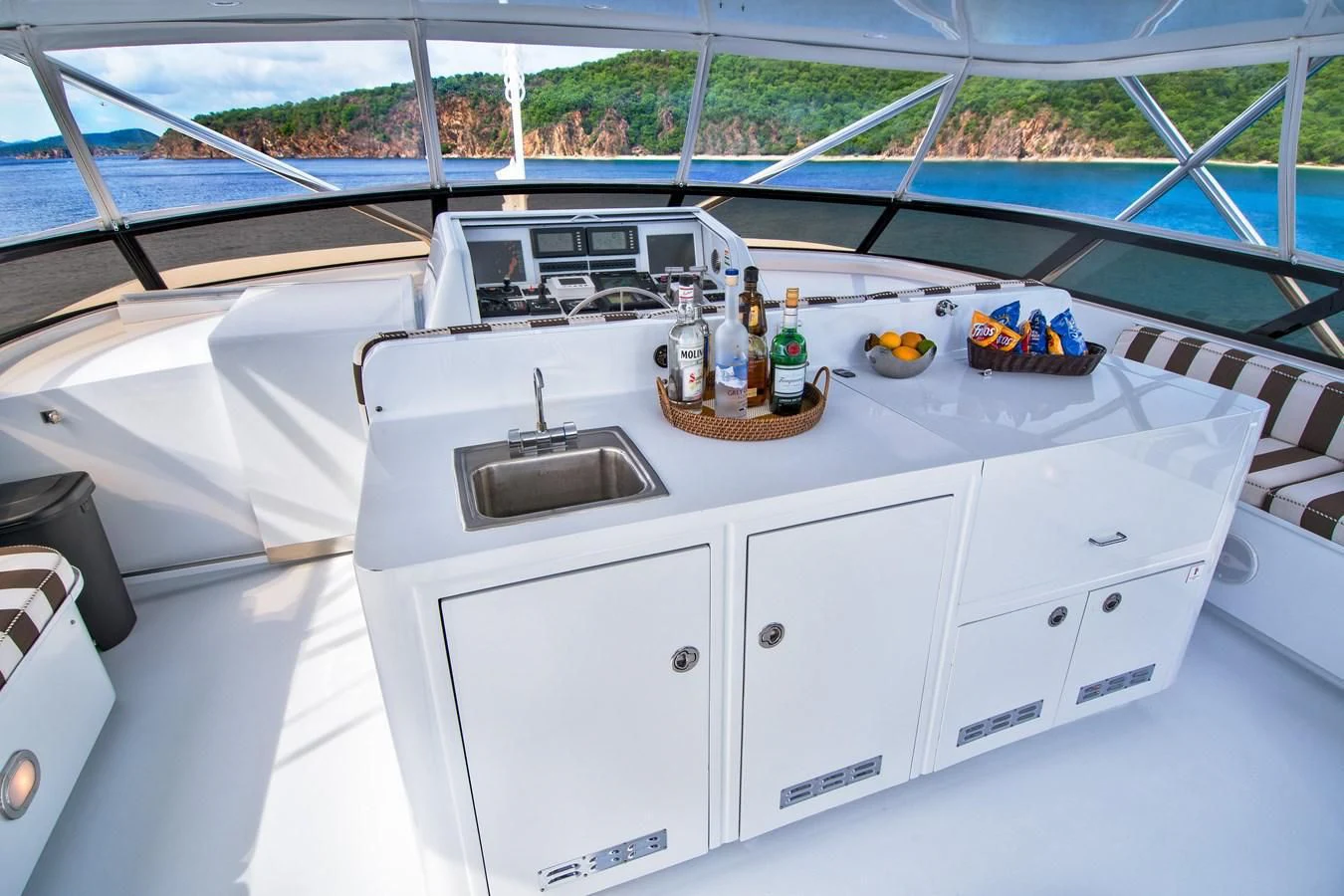 a kitchen with a sink and a basket of food on the counter aboard THREE KINGS Yacht for Sale
