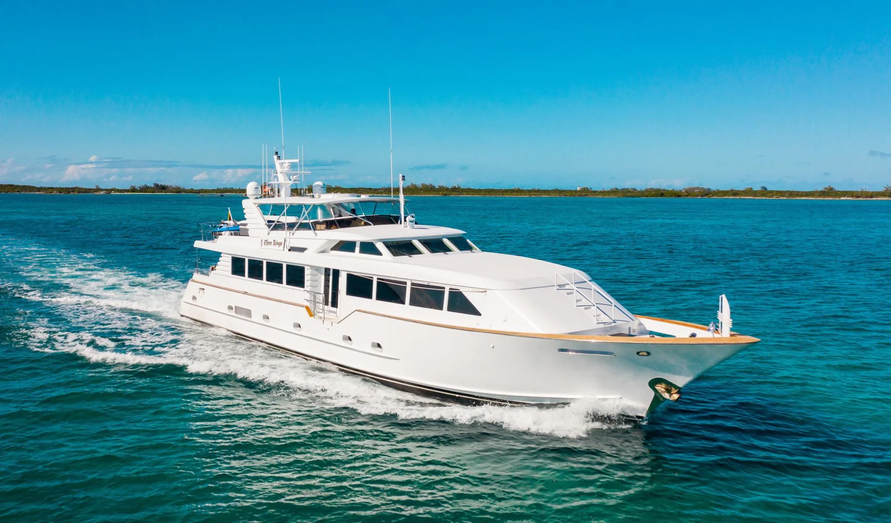 a white yacht on the water aboard THREE KINGS Yacht for Sale