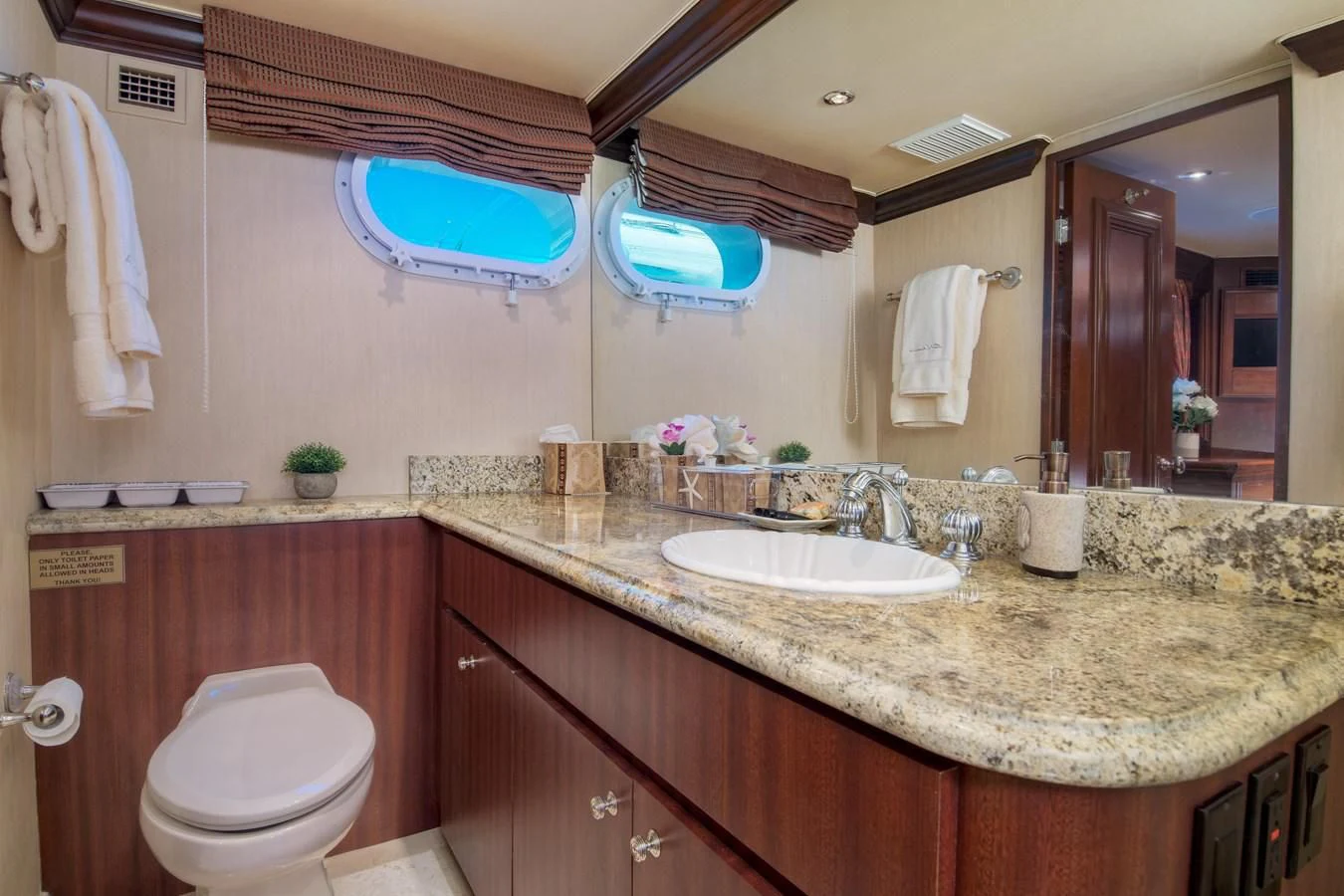 a bathroom with a countertop sink and a toilet aboard THREE KINGS Yacht for Sale