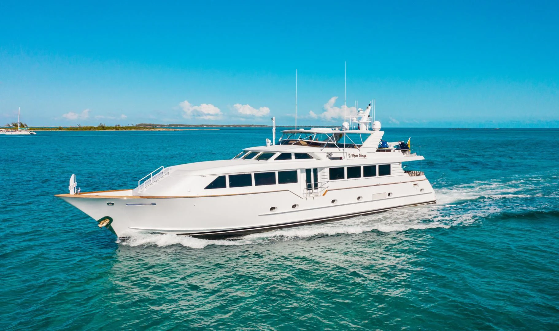 a white yacht in the water aboard THREE KINGS Yacht for Sale