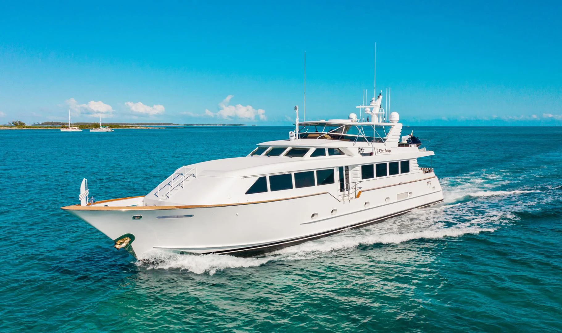 a white yacht on the water aboard THREE KINGS Yacht for Sale