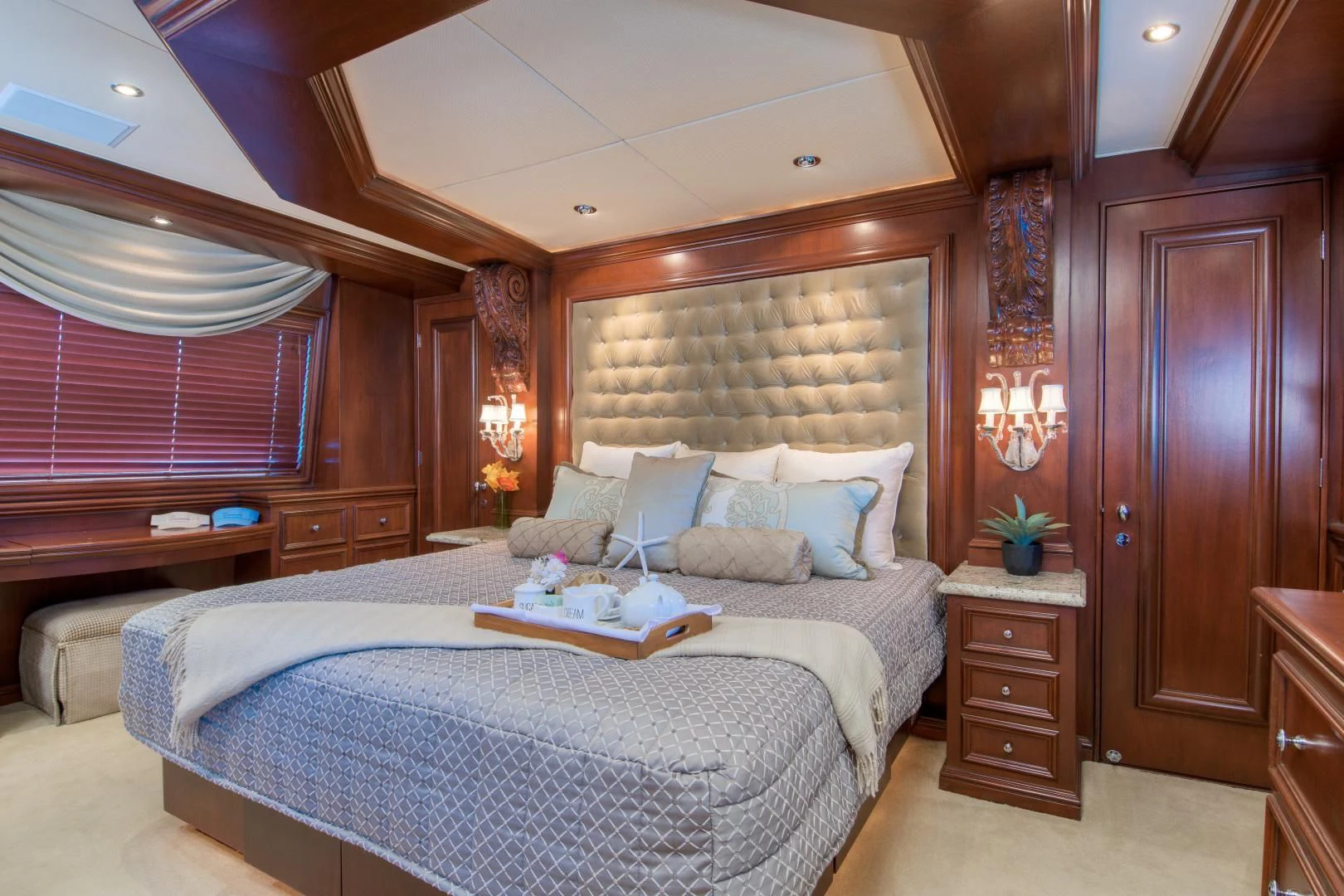 a bedroom with a bed and a desk aboard THREE KINGS Yacht for Sale