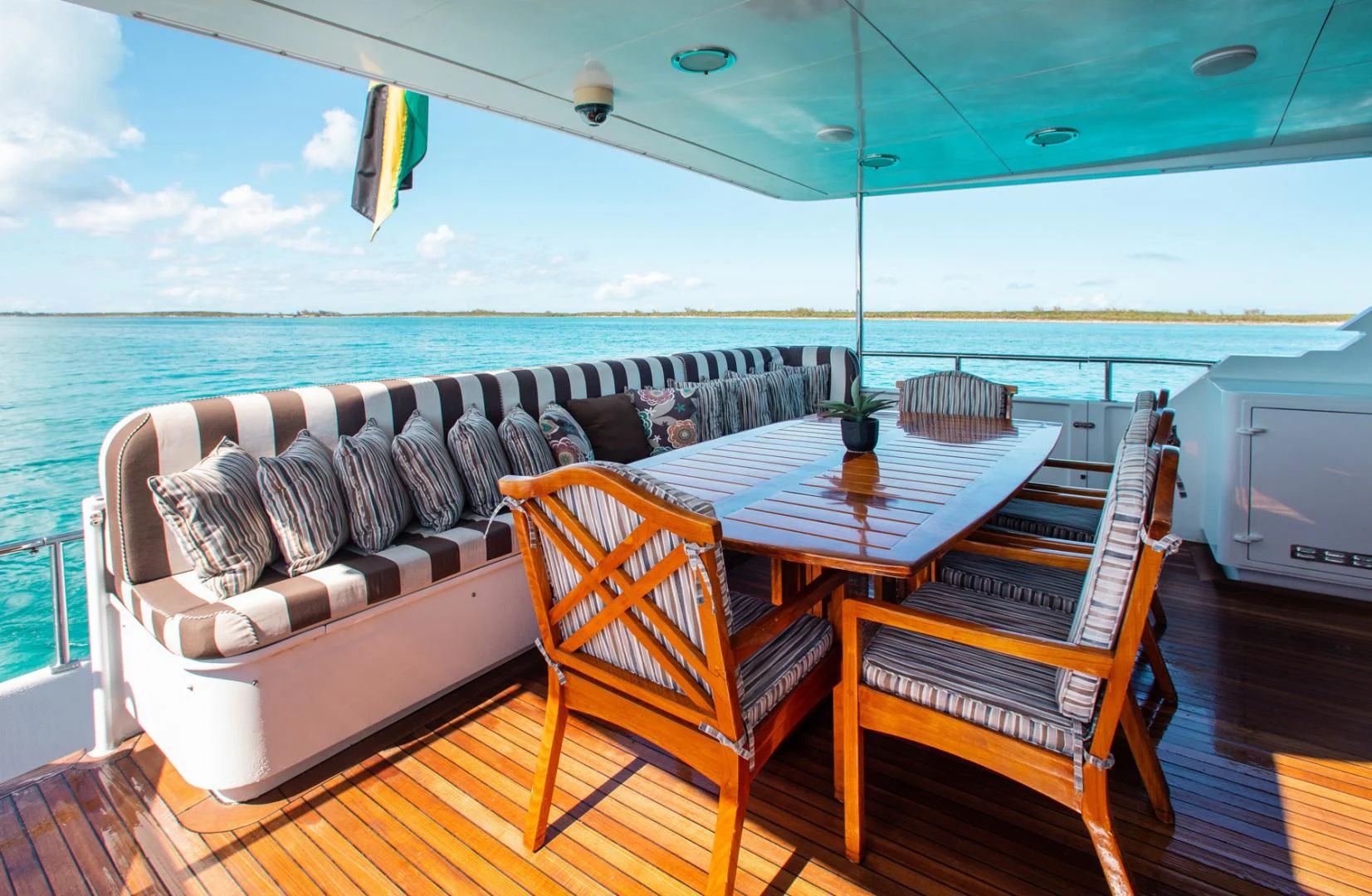 a table and chairs on a deck aboard THREE KINGS Yacht for Sale