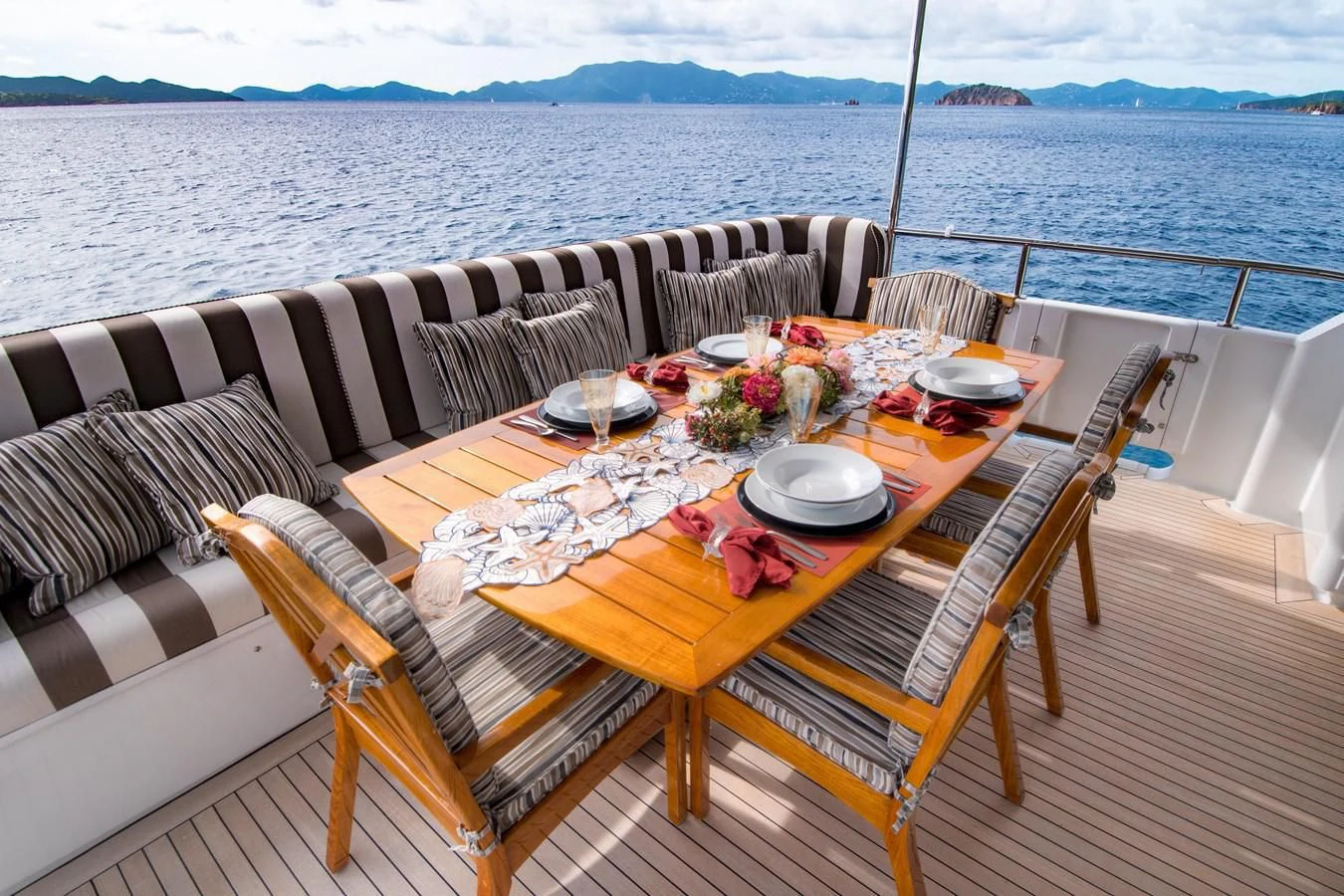 a table set for a meal on a boat aboard THREE KINGS Yacht for Sale
