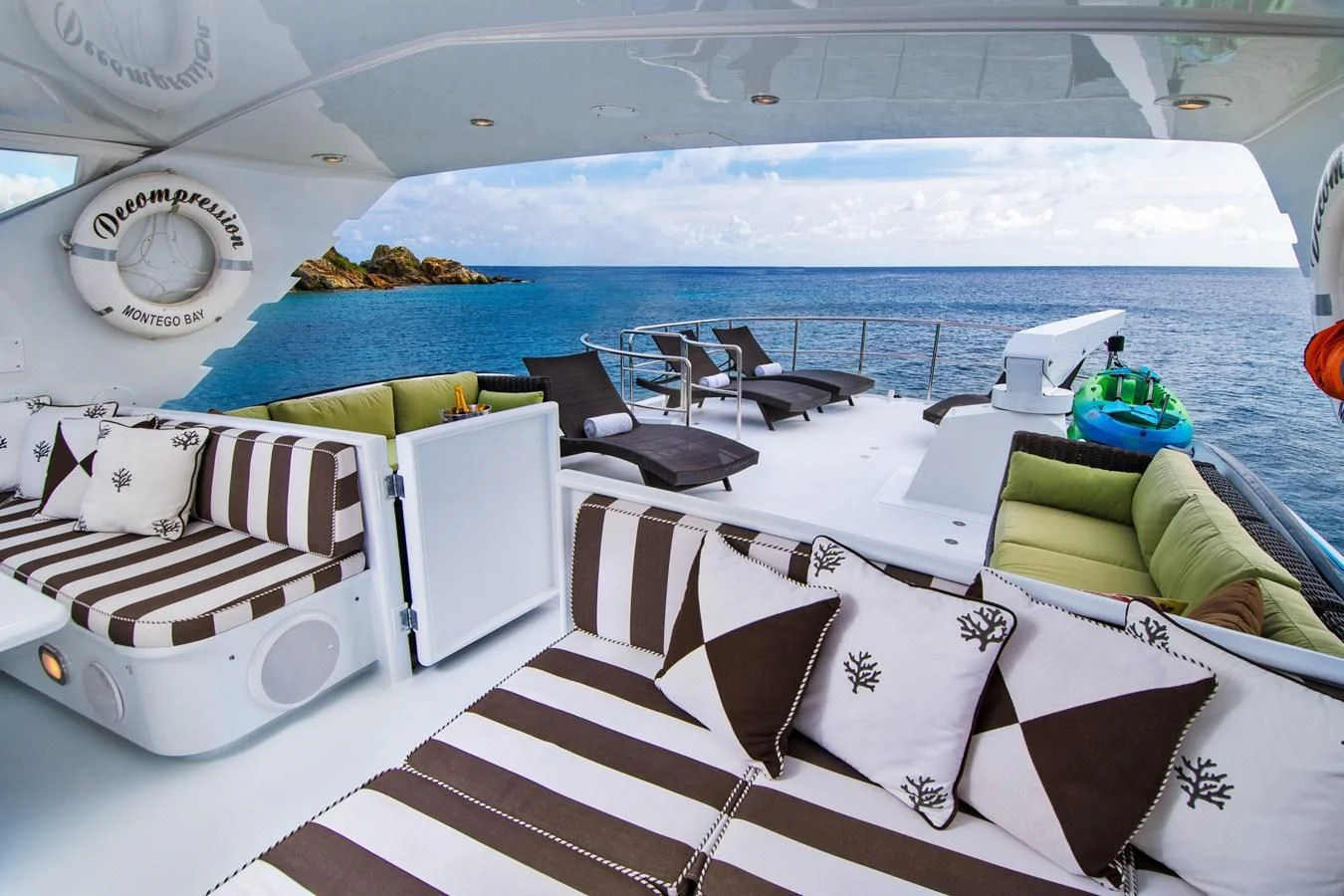a room with a pool and lounge chairs aboard THREE KINGS Yacht for Sale