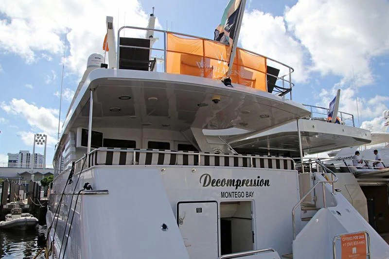 a large white boat in a harbor aboard THREE KINGS Yacht for Sale