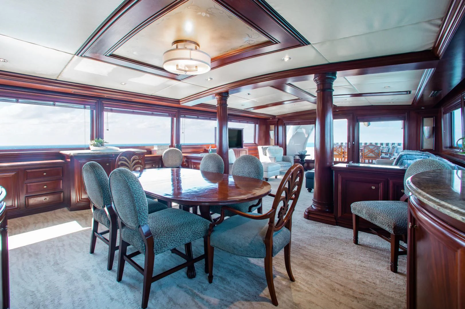 a large room with a table and chairs aboard THREE KINGS Yacht for Sale