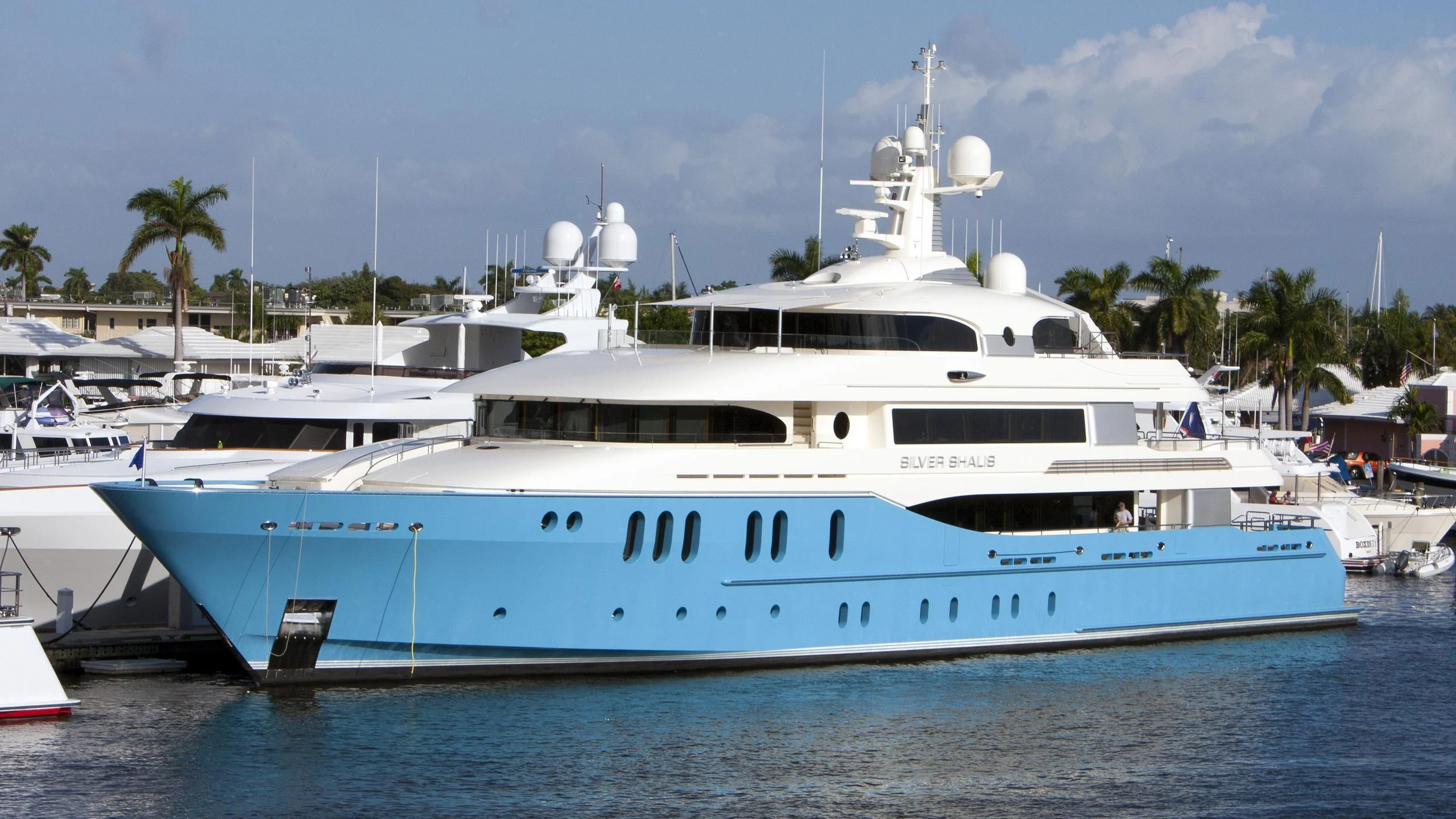 a large white boat in a harbor aboard SILVER SHALIS Yacht for Sale