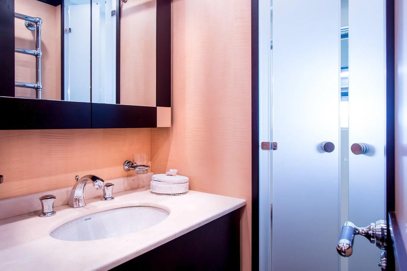 a bathroom with a sink and mirror aboard LEOPARD 24M Yacht for Sale