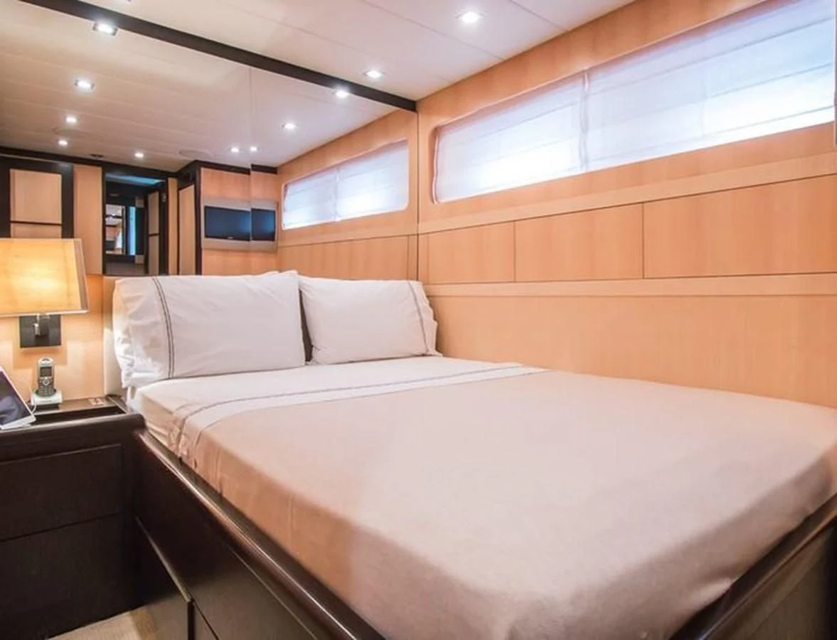 a bed with a white sheet aboard LEOPARD 24M Yacht for Sale