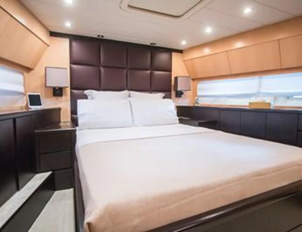 a bed with white sheets aboard LEOPARD 24M Yacht for Sale