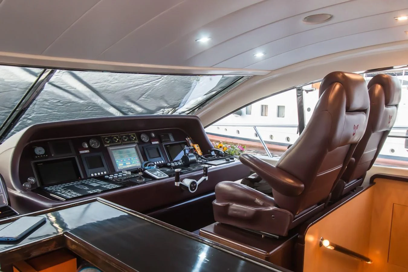 a person's hand on the steering wheel of a car aboard LEOPARD 24M Yacht for Sale