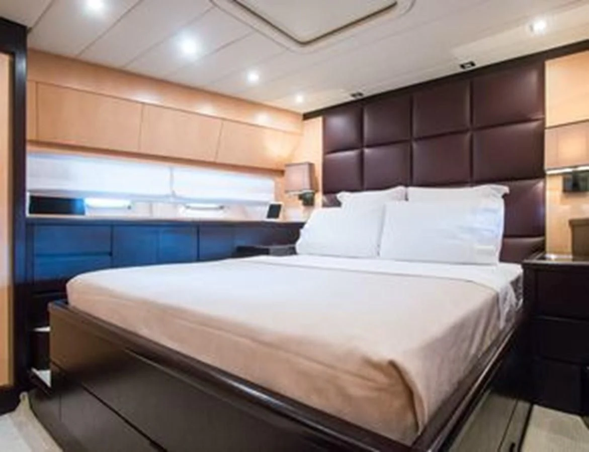 a bed with white sheets aboard LEOPARD 24M Yacht for Sale