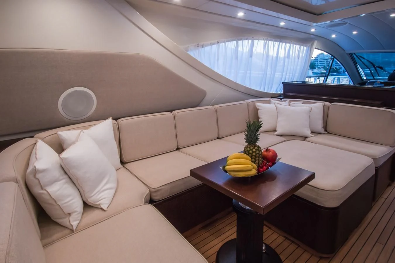 a room with couches and a table with fruit on it aboard LEOPARD 24M Yacht for Sale