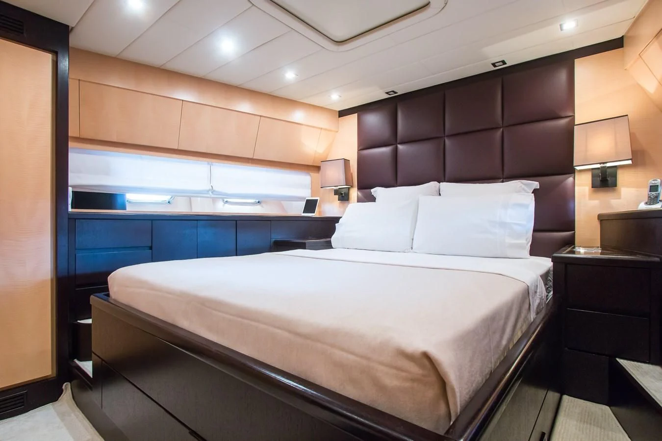 a bed with white sheets aboard LEOPARD 24M Yacht for Sale
