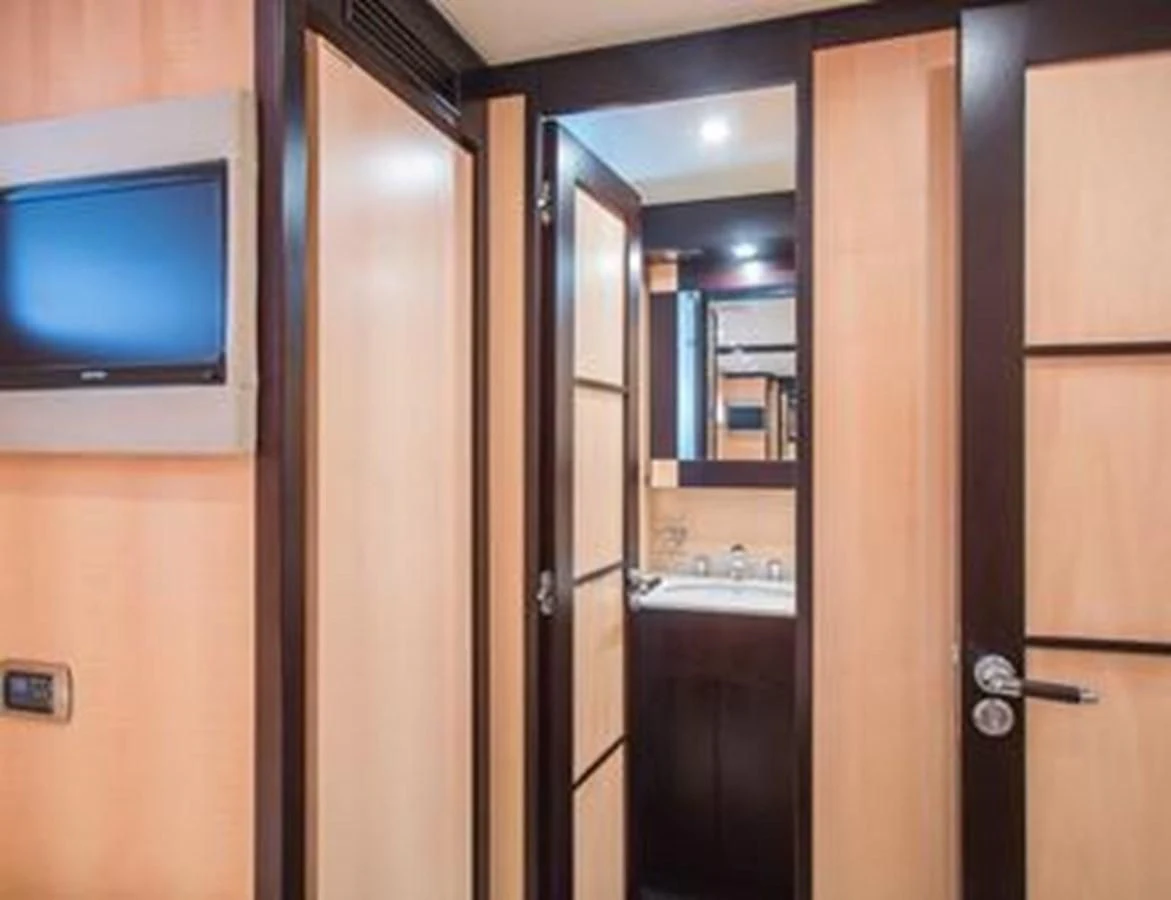 a room with a tv and a door aboard LEOPARD 24M Yacht for Sale