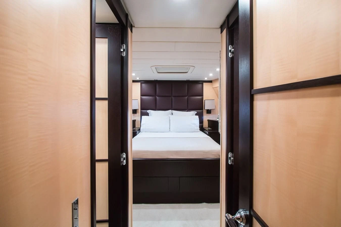 a room with a bed and a door aboard LEOPARD 24M Yacht for Sale