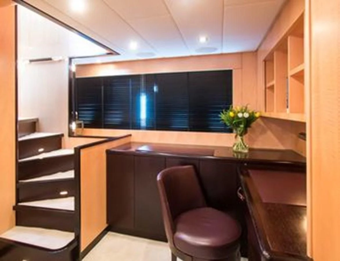 a kitchen with a bar and a chair aboard LEOPARD 24M Yacht for Sale