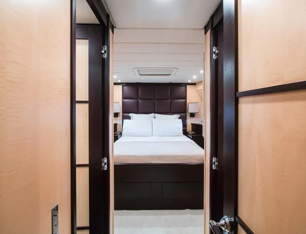 a room with a bed and a door aboard LEOPARD 24M Yacht for Sale