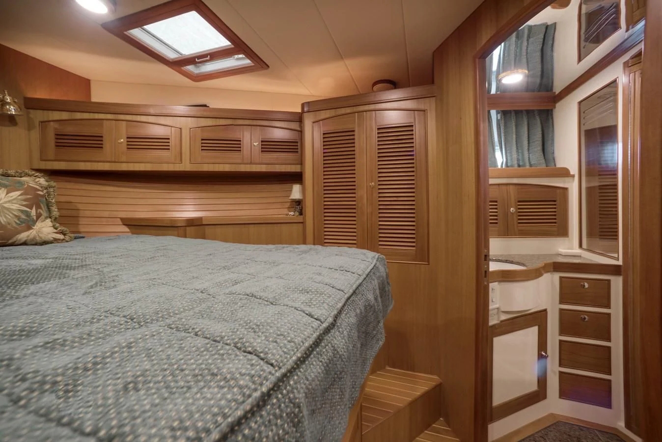 a bedroom with a bed and a desk aboard BLUE ROSY V Yacht for Sale