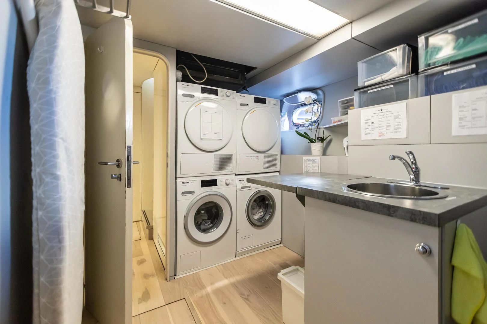 a room with a washing machine and sink aboard KARTAL YUVASI Yacht for Charter