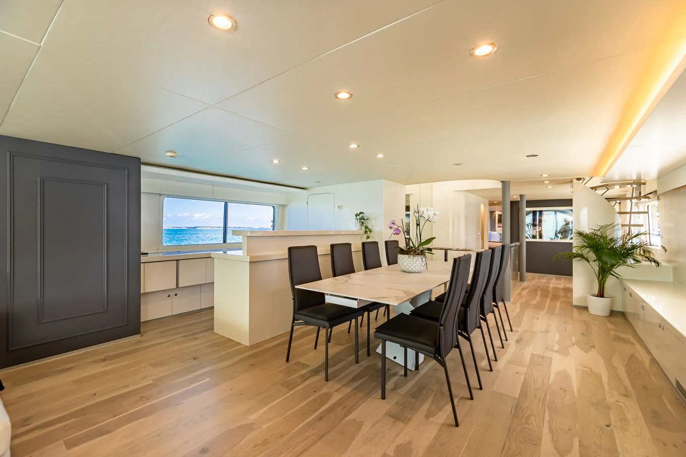 a large open floor plan with a dining table and chairs aboard KARTAL YUVASI Yacht for Charter