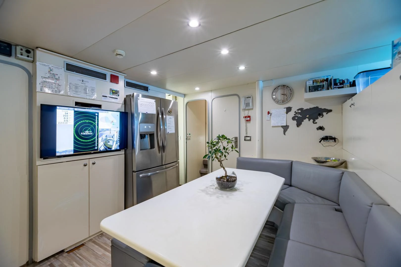 a kitchen with a table and a couch aboard KARTAL YUVASI Yacht for Charter