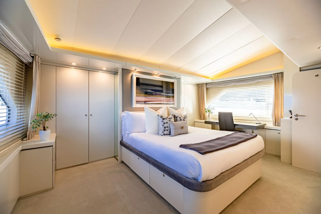 a bedroom with a bed and a chair aboard KARTAL YUVASI Yacht for Charter