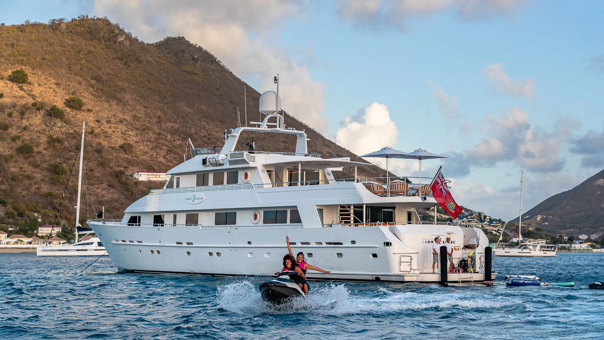 a large white boat with a couple of people on it aboard KARTAL YUVASI Yacht for Charter