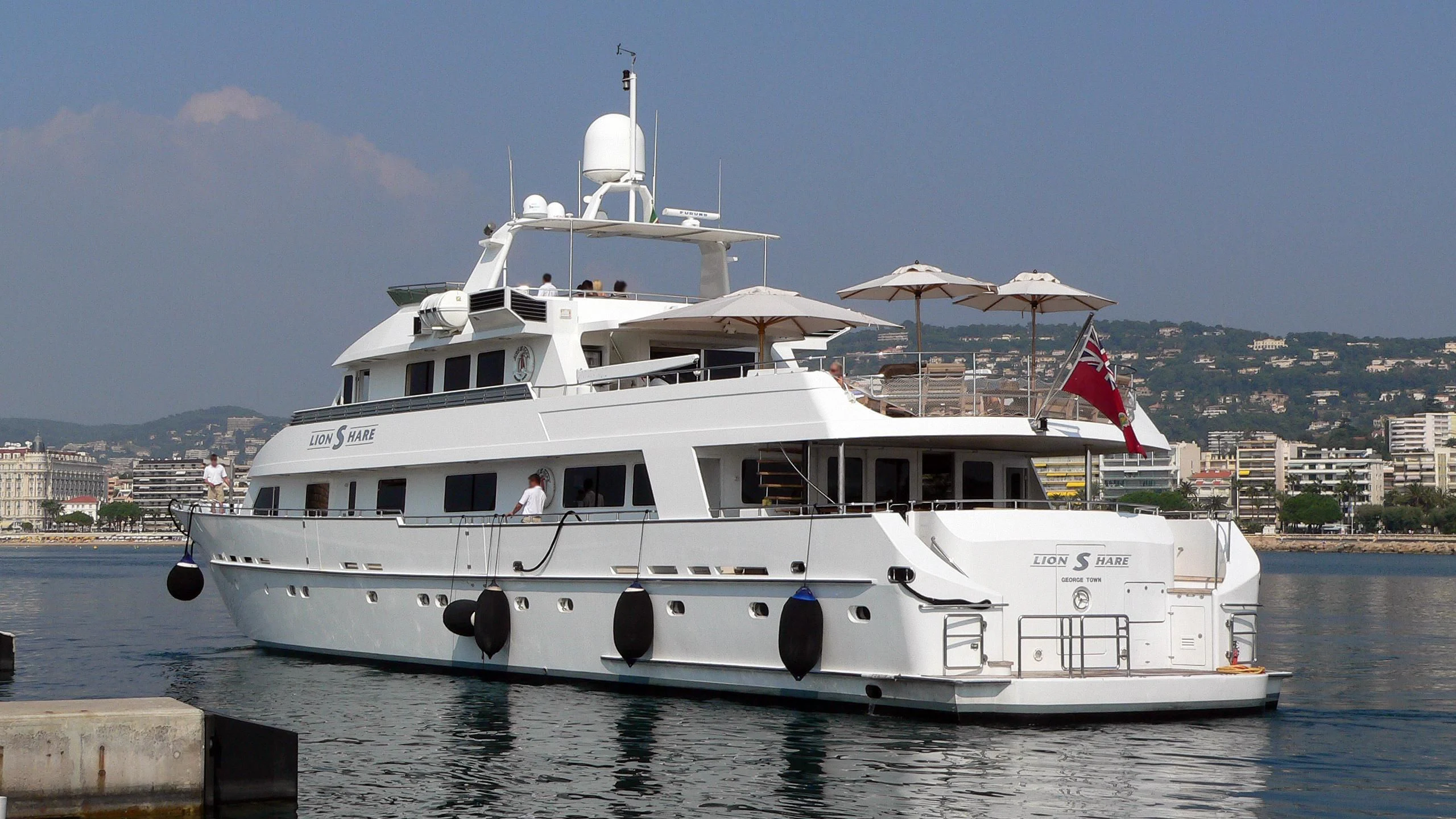 a large white boat with a flag on it aboard KARTAL YUVASI Yacht for Charter