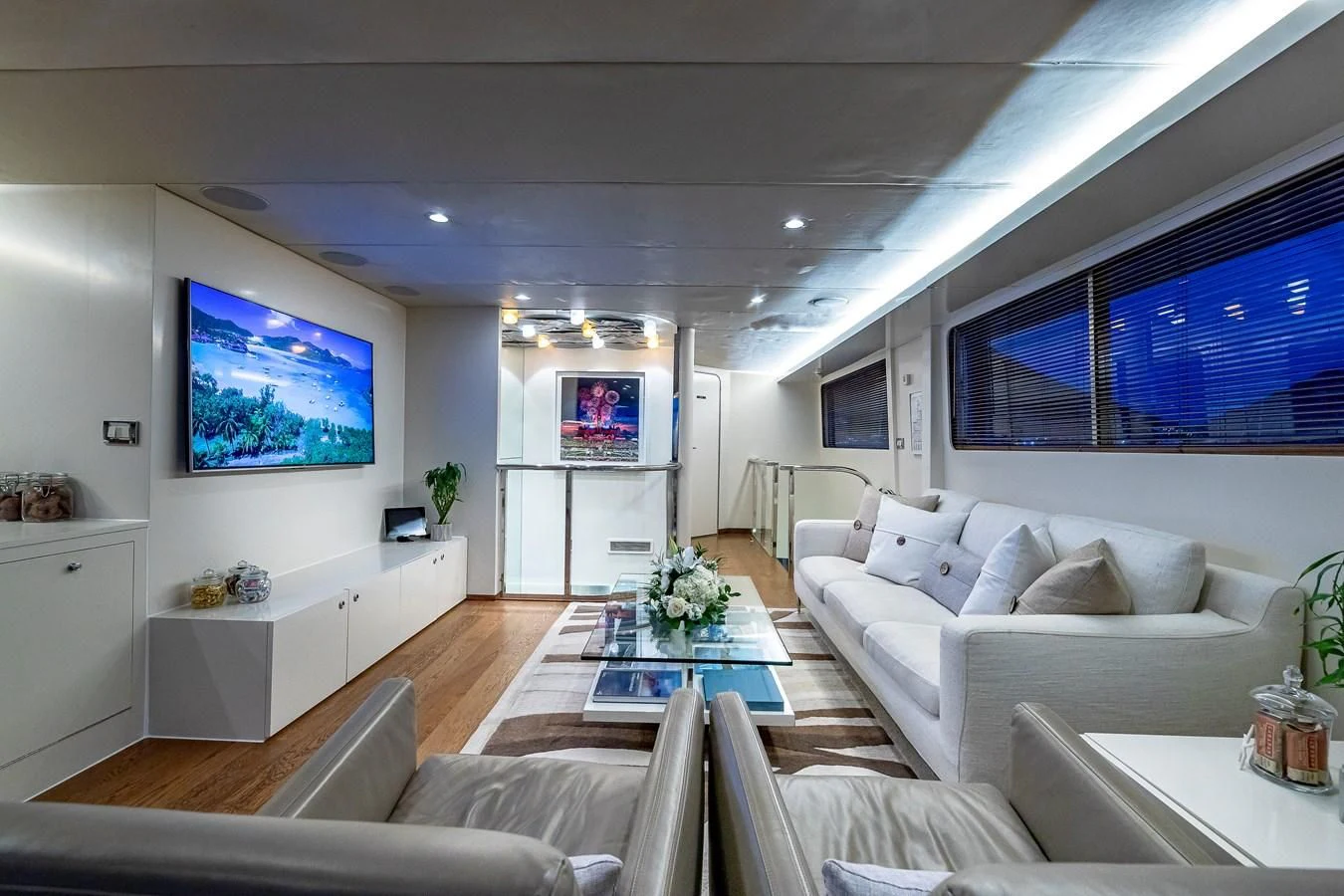 a living room with a large screen aboard KARTAL YUVASI Yacht for Charter