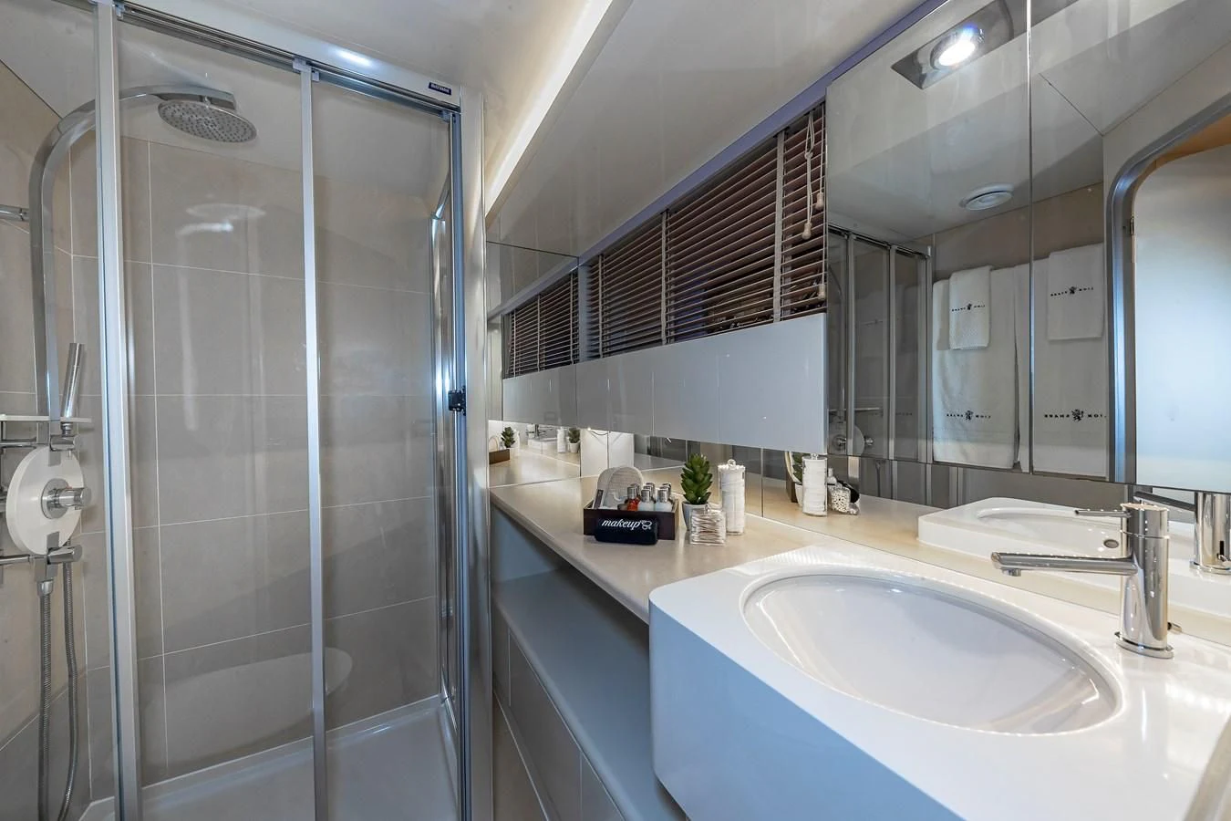 a bathroom with a glass shower aboard KARTAL YUVASI Yacht for Charter