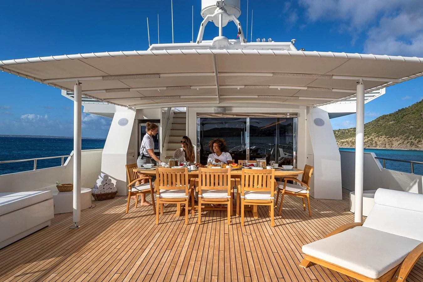 a group of people sitting at a table outside of a tent aboard KARTAL YUVASI Yacht for Charter