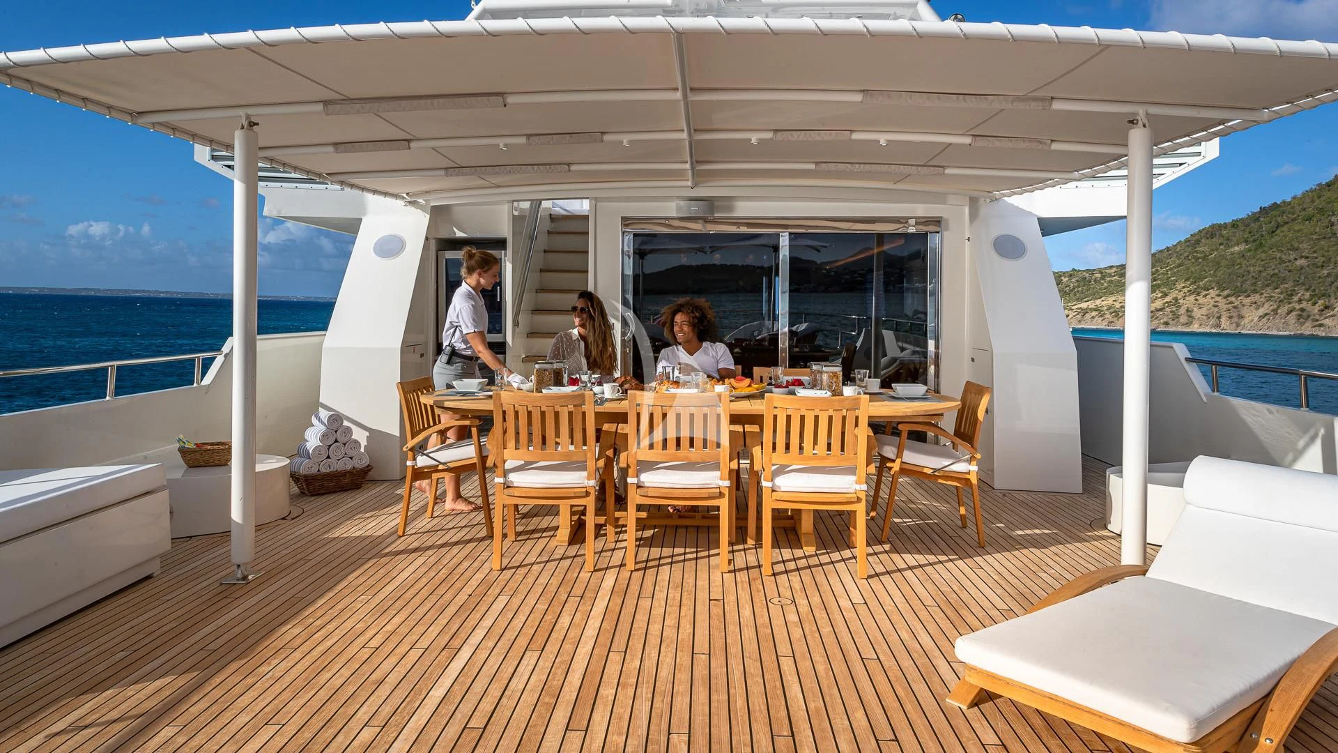 a group of people sitting around a table on a boat aboard KARTAL YUVASI Yacht for Charter