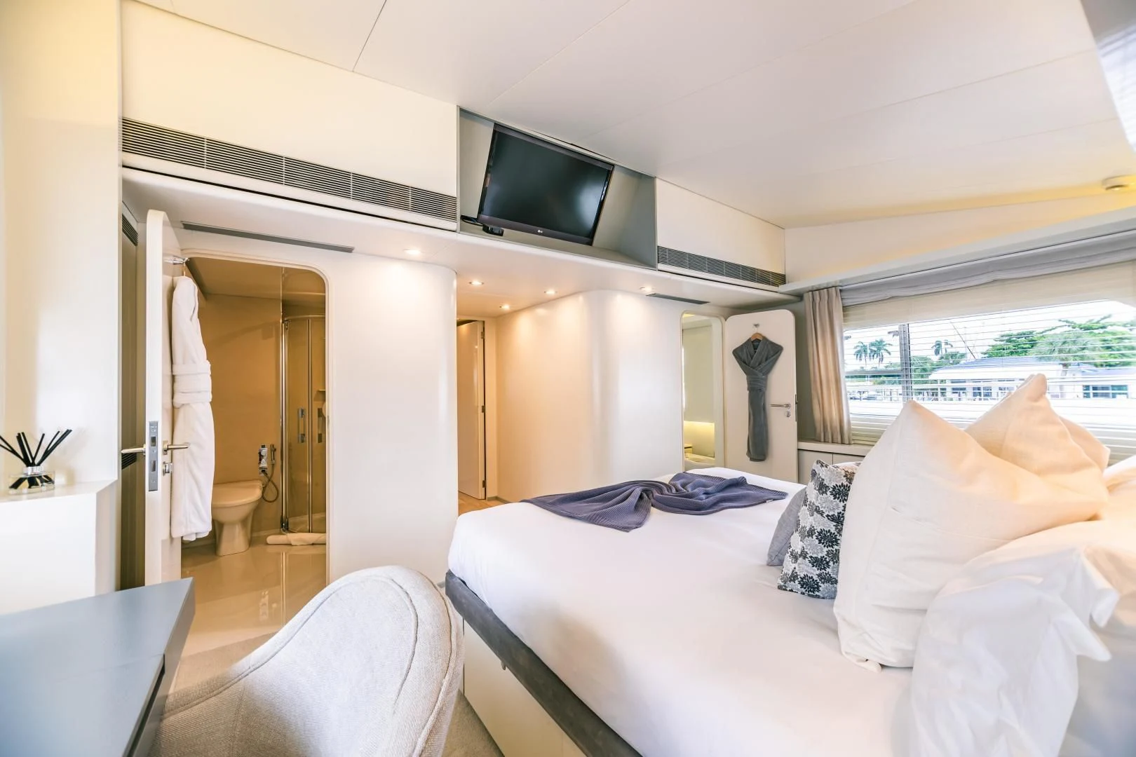 a bedroom with a bed and a television aboard KARTAL YUVASI Yacht for Charter