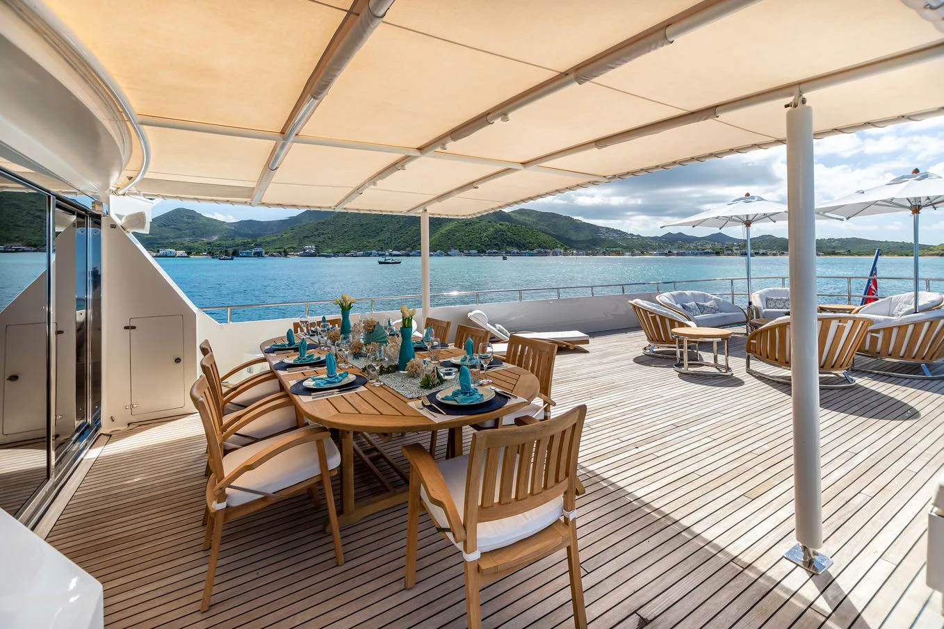 a deck with a table and chairs on it aboard KARTAL YUVASI Yacht for Charter
