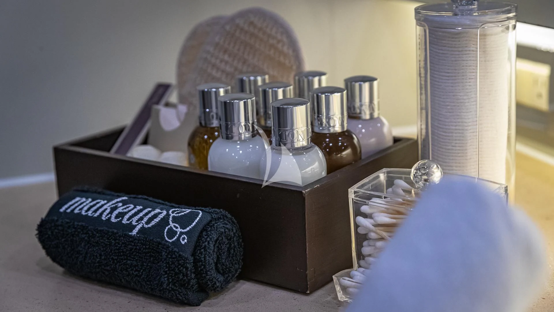 a box with a bottle and a hat on it aboard KARTAL YUVASI Yacht for Charter